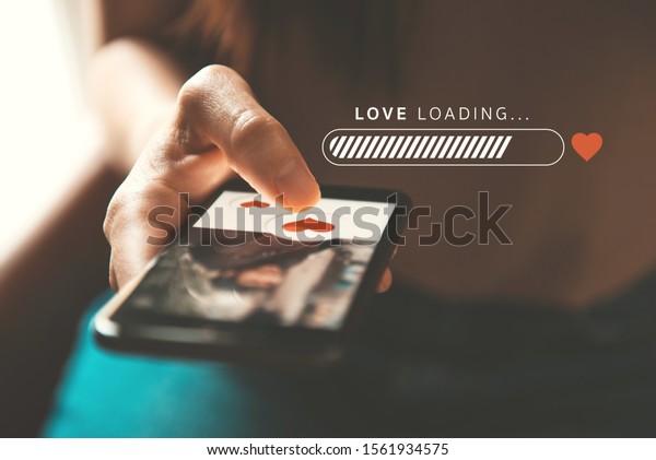 Love loading progress, Finger of\
woman pushing heart icon on screen in mobile smartphone\
application. Online dating app, valentine\'s day concept. Mockup\
website.