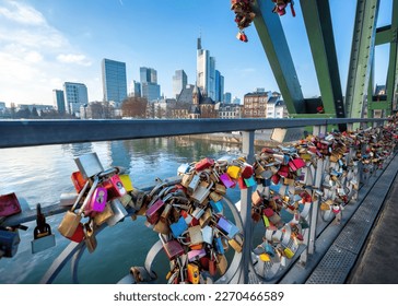 Love Locks at Eiserner Steg (Iron Footbridge) at River Main and skyscrapers skyline - Frankfurt, Germany
