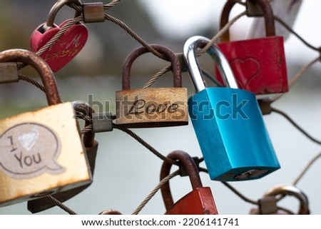 Love locks hang on the fence of the pedestrian Makartsteg Bridge (Love Lock Bridge) above the Salzach River in Salzburg, Austria.