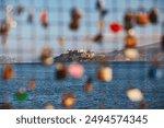 Love Locks on a Fence at Pier 41 in San Francisco with Alcatraz Island in the Background.