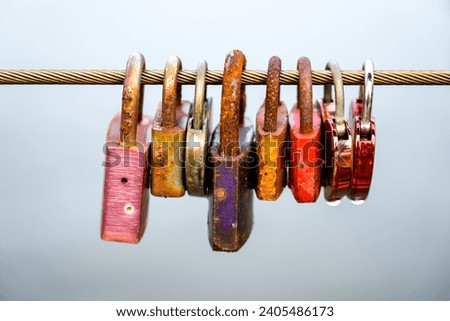 Love locks on a wire rope in a row. Objects in close-up	