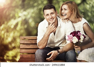 Love And Marriage Concept. Young Attractive Cheerful Couple In The Park And Smiling. Woman Responded To A Marriage Proposal.