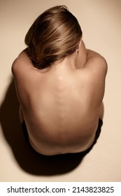 I love me. Top view of a young woman embracing her kness in the studio.