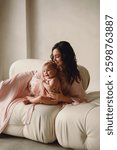 Love of a mother and baby. Mum and baby. Photoshooting in the studio of mother and daughter. Family love and care. Womans day