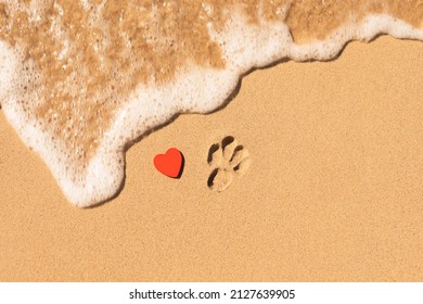 I love my dog message written in the sand at the beach. Dog paw print and heart, concept design for pet lovers, a condolence concept for death of a pet dog
