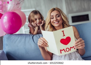 I Love My Mom! Attractive Young Woman With Little Cute Girl Are Spending Time Together At Home. Happy Family Concept. Mother's Day.