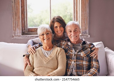 I Love My Parents. A Cropped Portrait Of A Happy Senior Couple And Their Adult Daughter At Home.