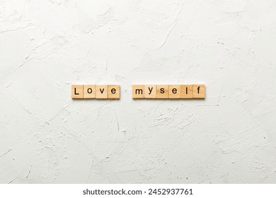 Love myself word written on wood block. Love myself text on cement table for your desing, Top view concept. - Powered by Shutterstock