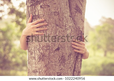 Similar – hands of woman hugging a tree