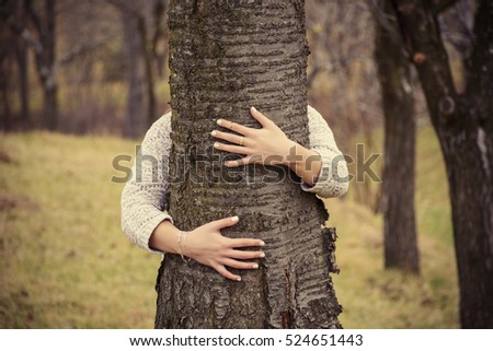 Similar – hands of woman hugging a tree