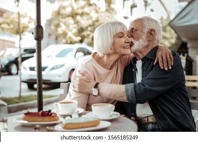 In love. Nice grey haired man kissing his wife while being still in love with her - Powered by Shutterstock