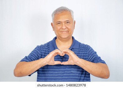 love and old people concept -  Happy senior man showing hand heart gesture and smiling, take care of the health, or being in love - Shutterstock ID 1480823978