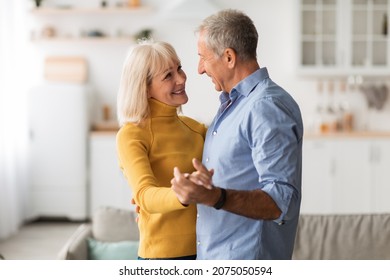 Love In Older Age. Loving Senior Couple Dancing At Home, Smiling To Each Other And Holding Hands Having Date. Happy Marriage, Romance And Long-Lasting Relationship Concept - Powered by Shutterstock