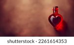 Love potion in a glass vessel. Bottle with love potion. Magic elixir for Valentines day.