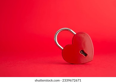 Love red heart shape padlock on red background with copy space. Find love, romantic, dating in online internet website, app dating community platform and Valentine day love symbol concept.
