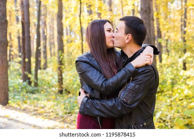 Love, relationship, family and people concept - man kissing his wife in autumn park - Shutterstock ID 1195878415