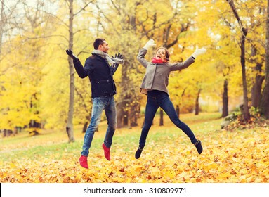love, relationship, family and people concept - smiling couple having fun in autumn park