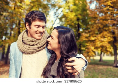 love, relationship, family and people concept - smiling couple hugging in autumn park - Shutterstock ID 317808620
