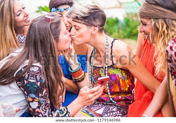 love relationship and friendship with two caucasian beautiful girls kissing eachother on the lips with love and gay lesbian way. diversity and sexual euqality concept for free alternative ladies 