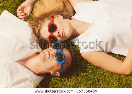 Similar – Two women with sunglasses smiling lying in blanket