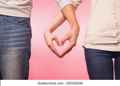 Love And Relationships Concept -  Woman And Man Hands Showing Heart Shape