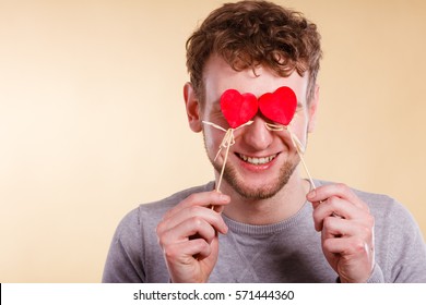 Love Romance Concept. Man Blinded By Love. Young Male Holding Hearts On Sticks Before His Eyes. 