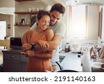 Love, romance and fun couple hugging, cooking in a kitchen and sharing an intimate moment. Romantic boyfriend and girlfriend embracing, enjoying their relationship and being carefree together