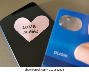 Love Scam Awareness Concept. A Person Holding Bank Card, Ready To Make Transactions For Scammer