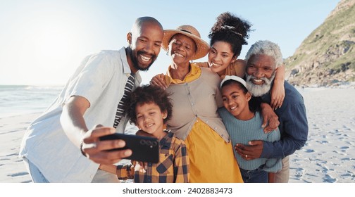 Love, selfie and happy family at a beach for travel, fun or adventure in nature together. Ocean, profile picture and African kids with parents and grandparents at the sea for summer, vacation or trip - Powered by Shutterstock