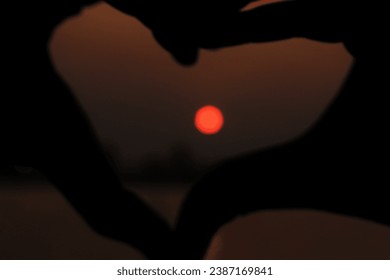 love shaped fingers as a moon frame - Powered by Shutterstock