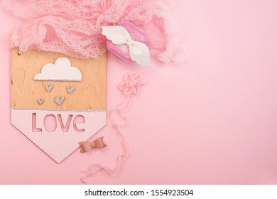 Love Signboard, Bows, Casket, Baby Hair Clips On A Pink Background With Place For Text For A Girl And A Child’s Room