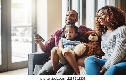 Love, smile and family on a couch, watching tv and bonding on a weekend break, home or chilling. Happy parents, mother or father with kid, female child or daughter on a sofa, happiness and television - Powered by Shutterstock