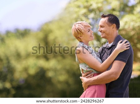 Love, smile and happy couple hug in park with trust, support or solidarity, security or bonding in nature. Commitment, eye contact or people embrace in forest for spring romance, fun or outdoor date
