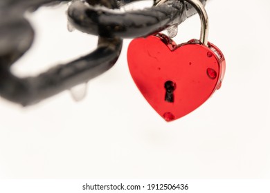 Love for sweethearts and relation memory in form of a lock as symbol for love, romance, eternity and endless love for couples on Valentines Day at a chain fence to celebrate wedding or romantic day