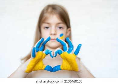 Love Ukraine Concept. Hands In Heart Form Painted In Ukraine Flag Color - Yellow And Blue.No War, Child Ask For Help. Selecrive Focus. 