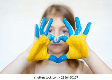 Love Ukraine Concept. Hands In Heart Form Painted In Ukraine Flag Color - Yellow And Blue.No War, Child Ask For Help. Selecrive Focus. 