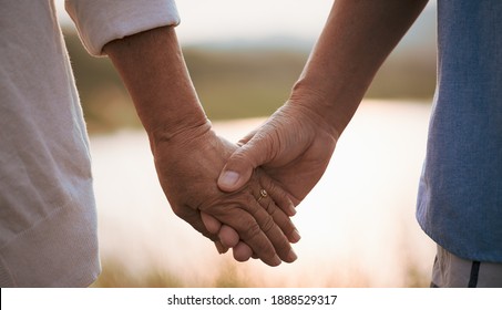Love and Valentine day concept. A happy senior couple holding hand  during sunset , Senior healthcare and relationship.