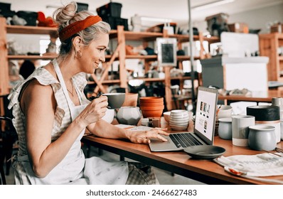 I love the way my website looks. Cropped shot of an attractive mature woman sitting alone and using her laptop in her pottery workshop while drinking coffee. - Powered by Shutterstock