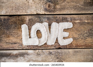  Love word from fabric on grunge old wooden background