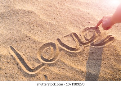 LOVE word writing on the white sand nature on the beach. summer trip