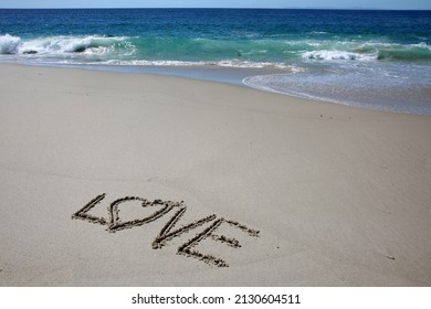 Love. Words written in beach sand. The word LOVE written in the sand on the beach with the ocean as the background. Love is all you need. Everyone Loves the beach. 