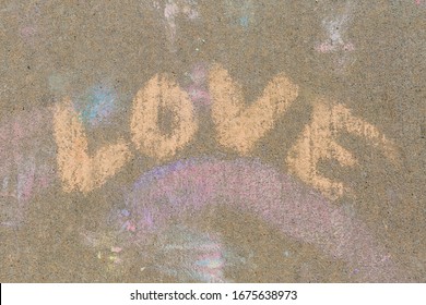 Love Written With Orange Sidewalk Chalk