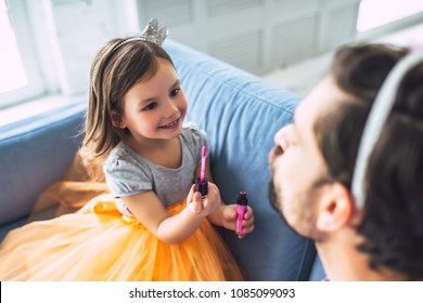 I Love You, Dad! Handsome Young Man At Home With His Little Cute Girl. Daughter Is Doing Makeup For Her Daddy. Happy Father's Day!