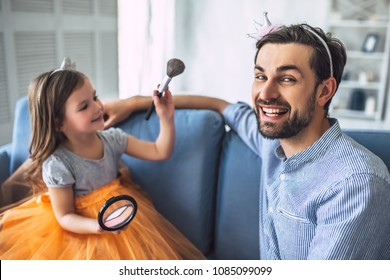 I Love You, Dad! Handsome Young Man At Home With His Little Cute Girl. Daughter Is Doing Makeup For Her Daddy. Happy Father's Day!