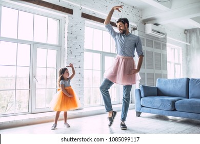 I Love You, Dad! Handsome Young Man At Home Is Dancing With His Little Cute Girl Wearing Skirt. Happy Father's Day!