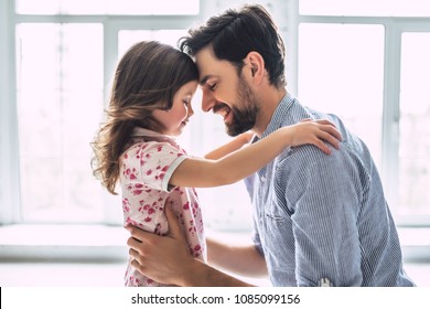 I love you, dad! Handsome young man at home with his little cute girl. Happy Father's Day! - Shutterstock ID 1085099156