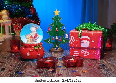 I Love you. Hearts, Red Candles, Love Presents. Christmas Gift Box Next to a Festive Christmas Tree and a Glass Snow Globe with Santa Claus Inside. Perfect Scene for Christmas and New Year Greetings.  - Powered by Shutterstock