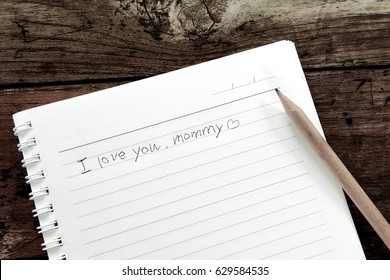 I love you mommy. the message on the notebook in handwriting with the grunge style photo 