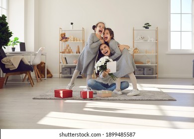 I love you so much. Excited young woman thanking her little children for birthday presents. Happy mom and cute funny kids hugging, laughing and having fun on Mother's or Women's Day - Powered by Shutterstock