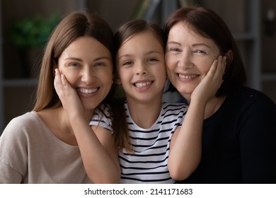 I Love You So Much Mommy And Granny. Headshot Portrait Of Affectionate Tween Girl Caress Cheeks Of Beloved Retired Grandmother Young Mother. Three Generations Of Women In Family Cuddle Look At Camera